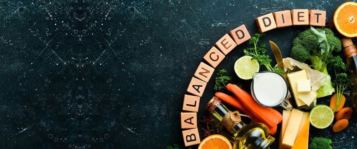 A balanced diet laid out on a dark surface